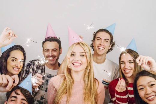 Jeunes adultes fêtant un anniversaire avec gâteaux et cotillons, ambiance conviviale et festive.