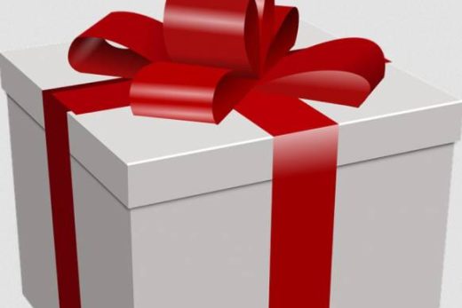 Coffret blanc noué d'un ruban rouge, esprit cadeau parfait pour anniversaire ou événement spécial.