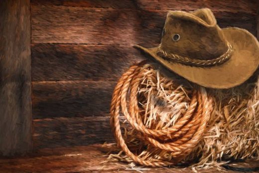 Chapeau de cowboy et lasso sur botte de foin, ambiance Far West authentique Laeris Escape Game Toulon.